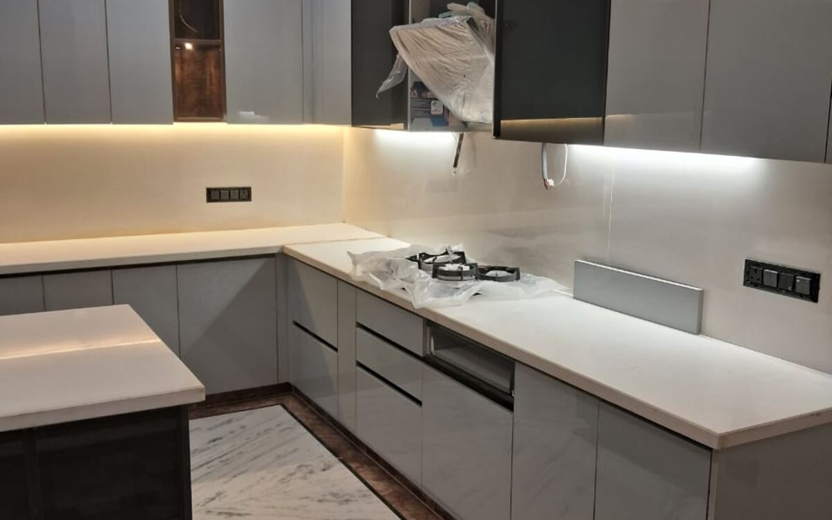 Grey L-shaped kitchen with profile lighting